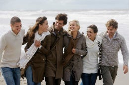 A group of friends walking together on the beach