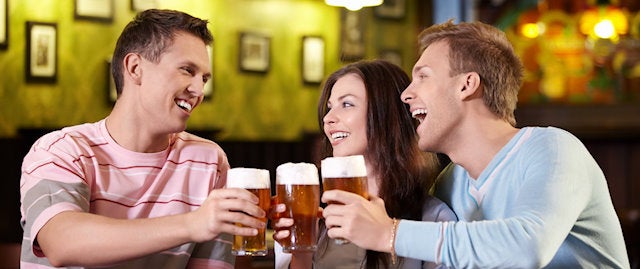 people cheersing their pints