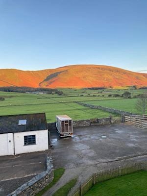   Sun illuminating a red hill