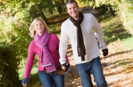 Be a Couple Again: Why Sometimes It’s Okay to Leave the Kids Behind A smiling middle-aged couple, holding hands, laughing, walking through the woods.