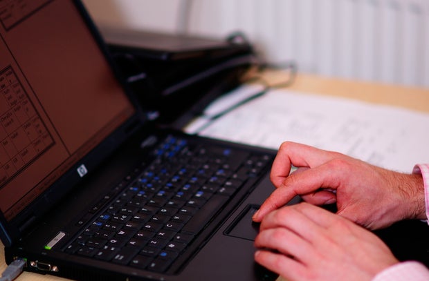 A business man at his laptop, using WiFi on holiday to get on with work.