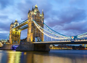 Tower Bridge shining brightly as the dark sky sets in over London